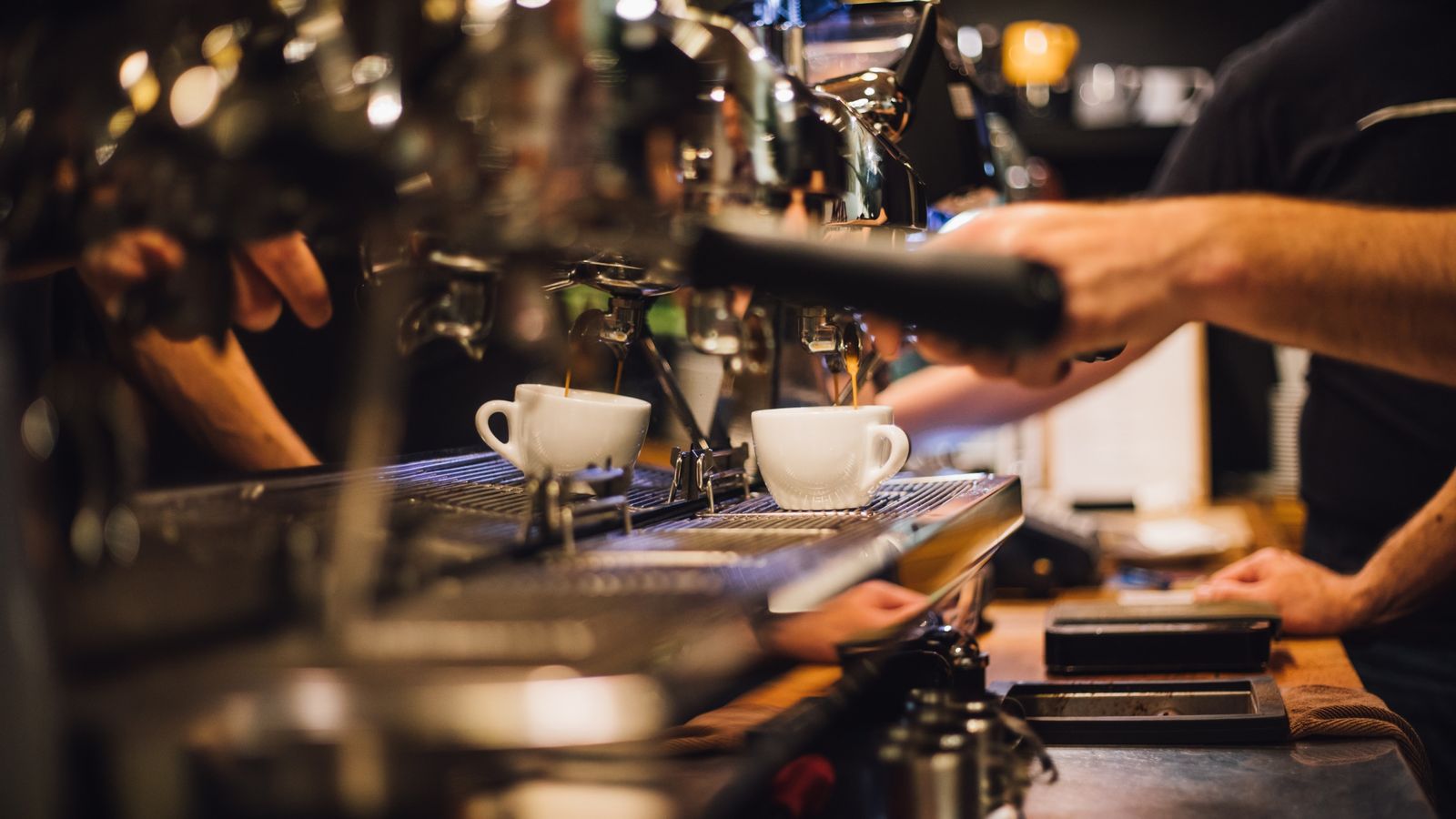 A barista making coffee at a local café